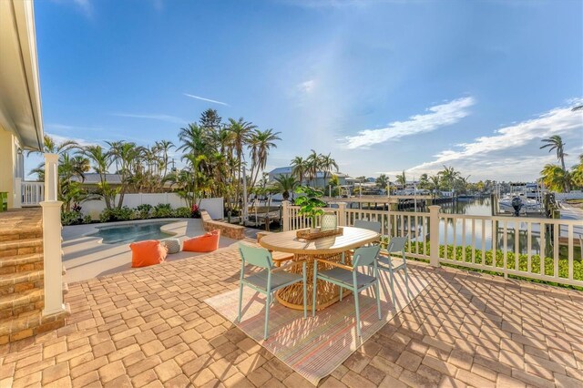 634 Key Royale Dr, Holmes Beach, FL 34217 - view of patio with a water view, outdoor dining space, and an outdoor pool