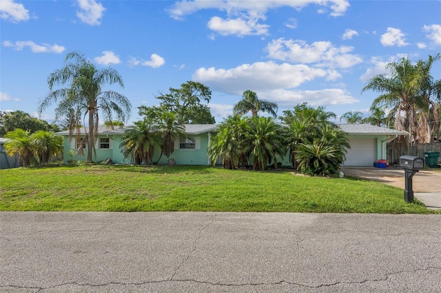 225 Sherwood Ln, Daytona Beach, FL 32117 - view of front of home featuring concrete driveway, an attached garage, and a front lawn