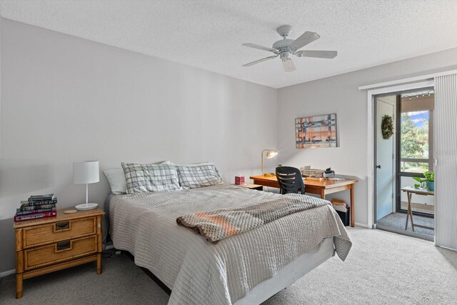 3500 El Conquistador Pkwy Unit 132, Bradenton, FL 34210 - bedroom with access to outside, carpet flooring, a desk, a textured ceiling, and baseboards
