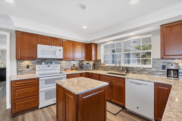 2005 21st St W, Palmetto, FL 34221 - kitchen featuring white appliances, a sink, ornamental molding, tasteful backsplash, and light stone counters