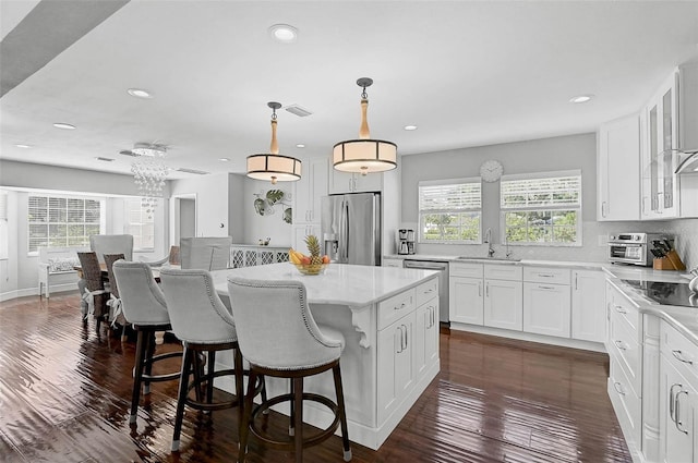 13514 4th Plz E, Bradenton, FL 34212 - kitchen featuring appliances with stainless steel finishes, plenty of natural light, a center island, white cabinets, and recessed lighting