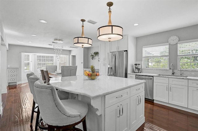 13514 4th Plz E, Bradenton, FL 34212 - kitchen featuring appliances with stainless steel finishes, healthy amount of natural light, white cabinets, and recessed lighting