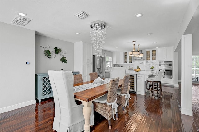 13514 4th Plz E, Bradenton, FL 34212 - dining area featuring dark wood finished floors, a chandelier, recessed lighting, and beverage cooler