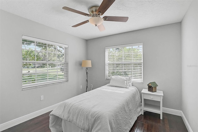 13514 4th Plz E, Bradenton, FL 34212 - bedroom featuring dark wood-style floors, a textured ceiling, and a ceiling fan