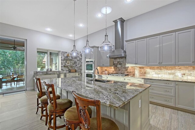 22343 Panther Loop, Bradenton, FL 34202 - kitchen featuring wall chimney exhaust hood, tasteful backsplash, appliances with stainless steel finishes, recessed lighting, and high vaulted ceiling