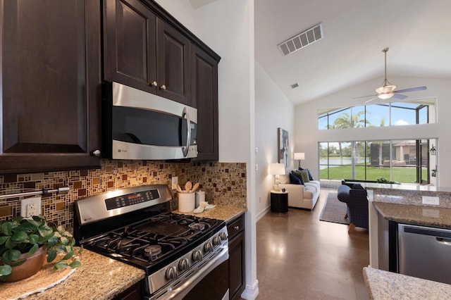 12031 Longview Lake Cir, Lakewood Ranch, FL 34211 - kitchen featuring appliances with stainless steel finishes, dark brown cabinets, light stone counters, decorative backsplash, and high vaulted ceiling