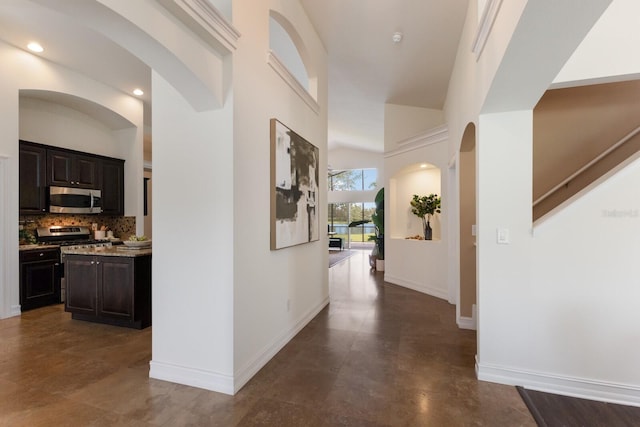 12031 Longview Lake Cir, Lakewood Ranch, FL 34211 - corridor featuring baseboards, arched walkways, and recessed lighting