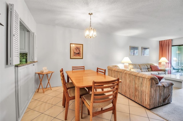 3500 El Conquistador Pkwy Unit 128, Bradenton, FL 34210 - dining area with light tile patterned flooring, a chandelier, and a textured ceiling