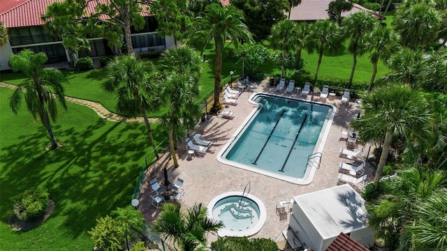 3500 El Conquistador Pkwy Unit 128, Bradenton, FL 34210 - community pool featuring a lawn, a community hot tub, and a patio area