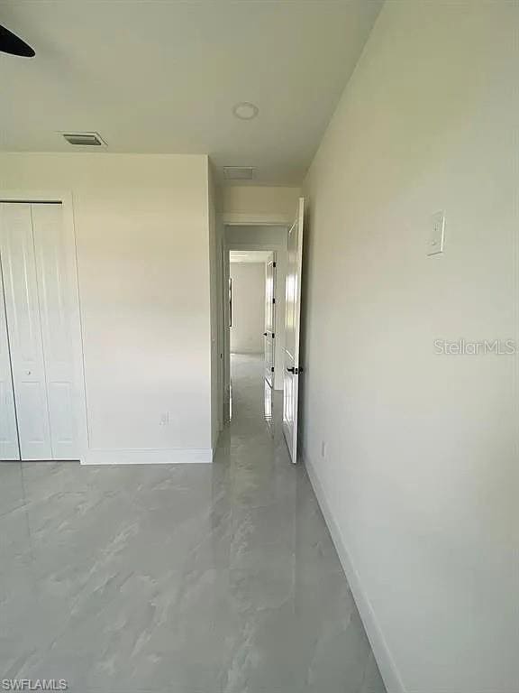 3017 4th St W, Lehigh Acres, FL 33971 - hallway with baseboards and concrete flooring