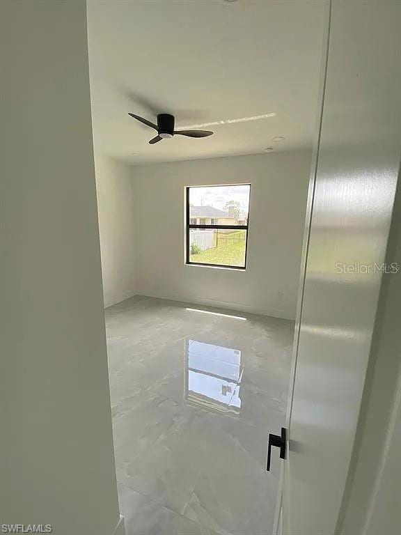3017 4th St W, Lehigh Acres, FL 33971 - unfurnished room featuring a ceiling fan