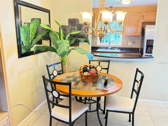 390 301st Blvd W Unit 2C, Bradenton, FL 34205 - dining space with light tile patterned floors and a chandelier
