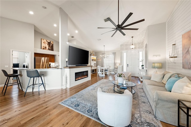 6750 64th Ter E, Bradenton, FL 34203 - living area featuring ceiling fan, light wood-type flooring, high vaulted ceiling, a chandelier, and recessed lighting