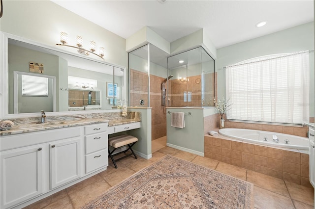 6750 64th Ter E, Bradenton, FL 34203 - full bath featuring a garden tub, a walk in shower, tile patterned flooring, and vanity