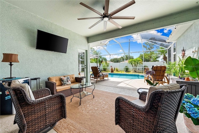 6750 64th Ter E, Bradenton, FL 34203 - fenced backyard featuring a patio area, ceiling fan, outdoor lounge area, and glass enclosure