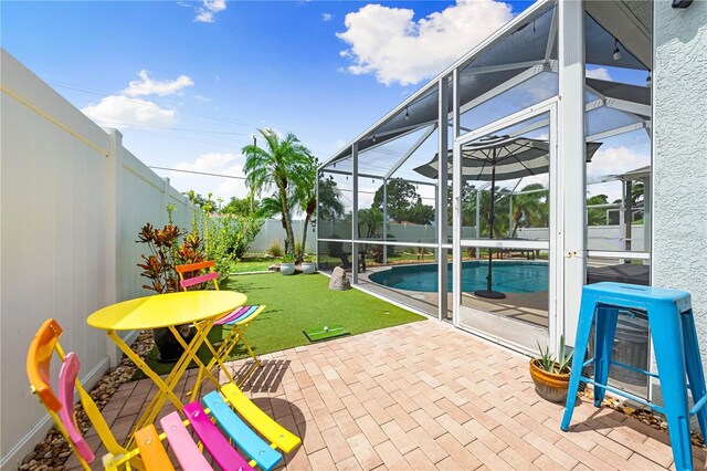 6750 64th Ter E, Bradenton, FL 34203 - view of swimming pool featuring a fenced backyard, a patio, and glass enclosure