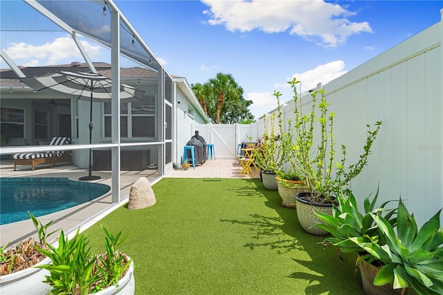 6750 64th Ter E, Bradenton, FL 34203 - fenced backyard featuring a patio and glass enclosure