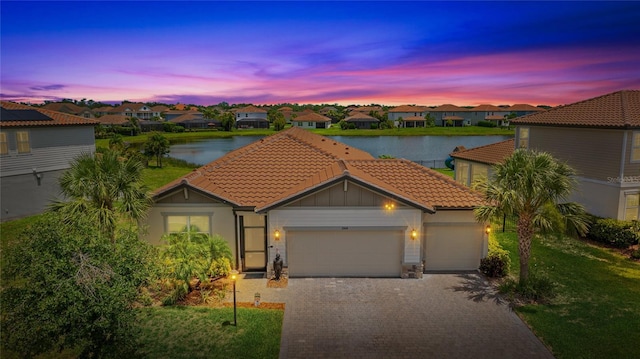 3504 Big Sky Way, Bradenton, FL 34211 - view of front of house with a tile roof, a water view, an attached garage, and a residential view