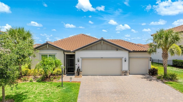 3504 Big Sky Way, Bradenton, FL 34211 - view of front of home featuring a garage, a tiled roof, decorative driveway, and stone siding