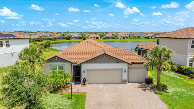 3504 Big Sky Way, Bradenton, FL 34211 - view of front of house with a residential view, a tile roof, a water view, a garage, and a front yard