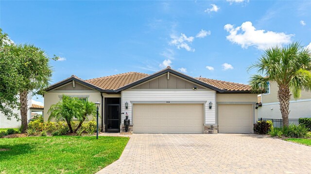 3504 Big Sky Way, Bradenton, FL 34211 - single story home featuring a garage, a tiled roof, driveway, and stone siding