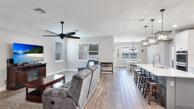 3504 Big Sky Way, Bradenton, FL 34211 - living area with light wood-style floors, baseboards, a chandelier, a ceiling fan, and recessed lighting