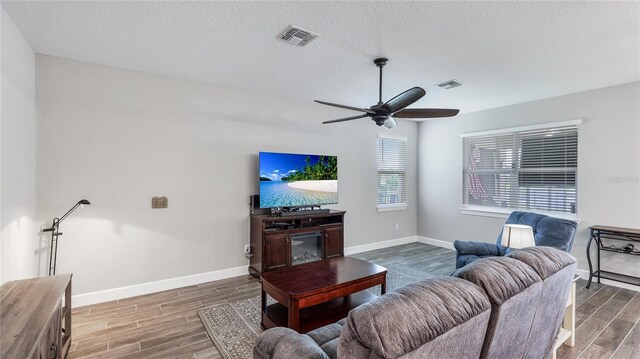 3504 Big Sky Way, Bradenton, FL 34211 - living room with wood finished floors, baseboards, ceiling fan, and a textured ceiling