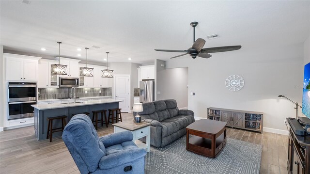 3504 Big Sky Way, Bradenton, FL 34211 - living area with light wood-style floors, recessed lighting, baseboards, and a ceiling fan