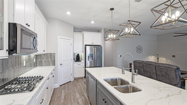 3504 Big Sky Way, Bradenton, FL 34211 - kitchen with stainless steel appliances, a sink, open floor plan, a chandelier, and recessed lighting