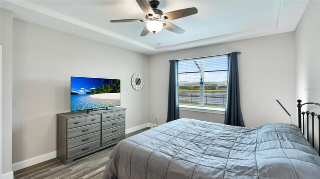 3504 Big Sky Way, Bradenton, FL 34211 - bedroom featuring wood tiled floors, baseboards, a raised ceiling, and ceiling fan