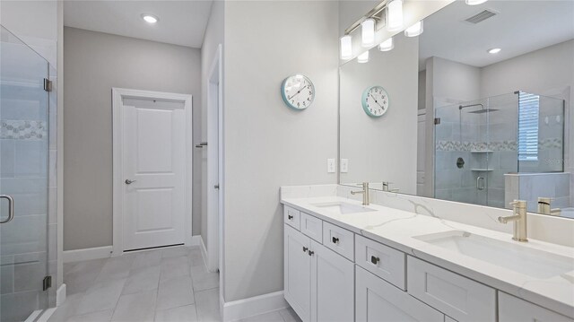 3504 Big Sky Way, Bradenton, FL 34211 - full bath with double vanity, a stall shower, baseboards, and tile patterned floors