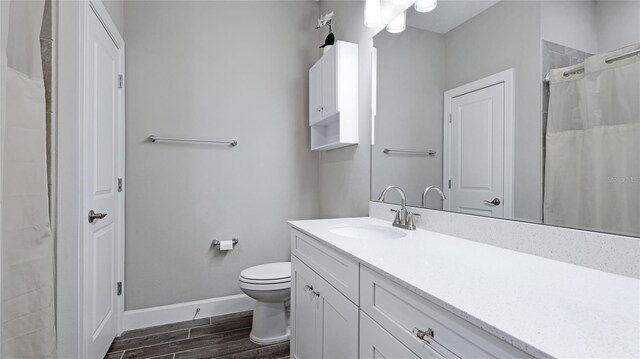 3504 Big Sky Way, Bradenton, FL 34211 - full bathroom with vanity, wood finished floors, toilet, baseboards, and a shower with curtain