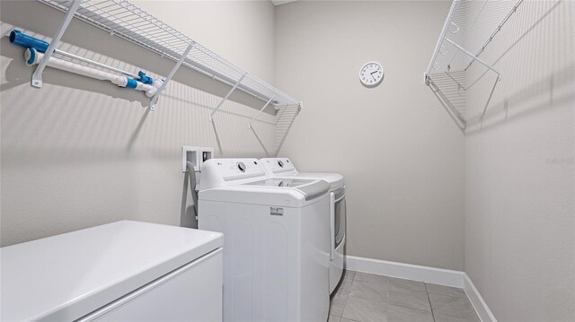 3504 Big Sky Way, Bradenton, FL 34211 - washroom featuring washing machine and clothes dryer, baseboards, and light tile patterned flooring