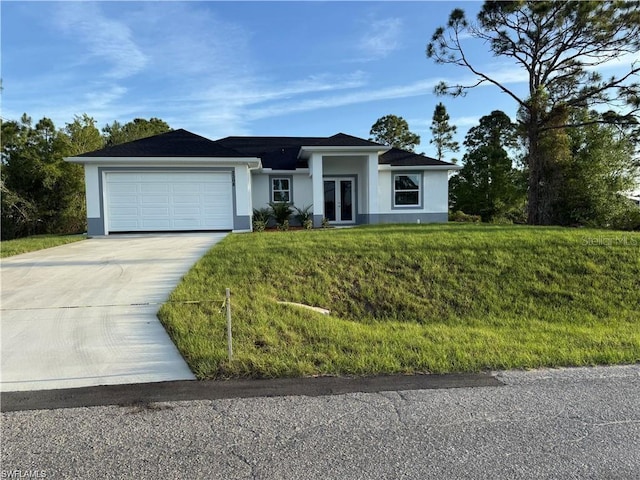 2906 18th St SW, Lehigh Acres, FL 33976 - view of front of home featuring driveway, stucco siding, a garage, a front lawn, and french doors