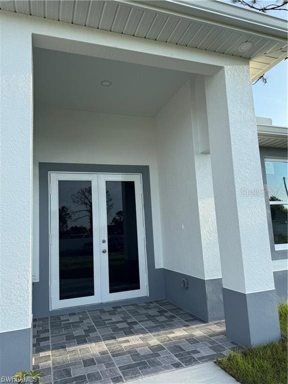 2906 18th St SW, Lehigh Acres, FL 33976 - property entrance with french doors and stucco siding