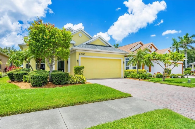 2085 Mattamy Ct, Venice, FL 34292 - view of front of home featuring driveway, an attached garage, stucco siding, and a front yard