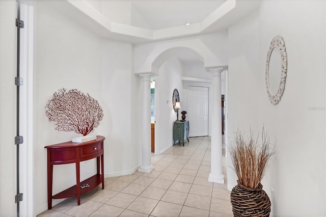 2085 Mattamy Ct, Venice, FL 34292 - hallway featuring decorative columns, arched walkways, light tile patterned floors, and a tray ceiling