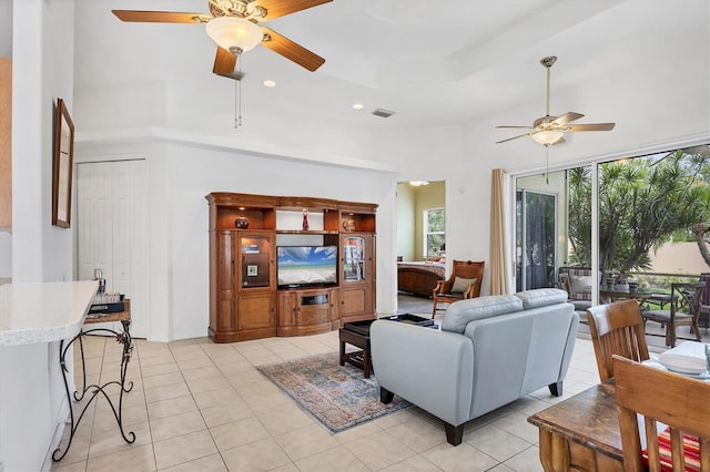 2085 Mattamy Ct, Venice, FL 34292 - living room featuring a ceiling fan, a towering ceiling, light tile patterned floors, and recessed lighting