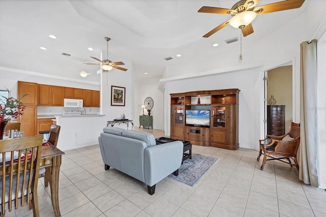 2085 Mattamy Ct, Venice, FL 34292 - living room featuring a ceiling fan, light tile patterned flooring, recessed lighting, and a high ceiling