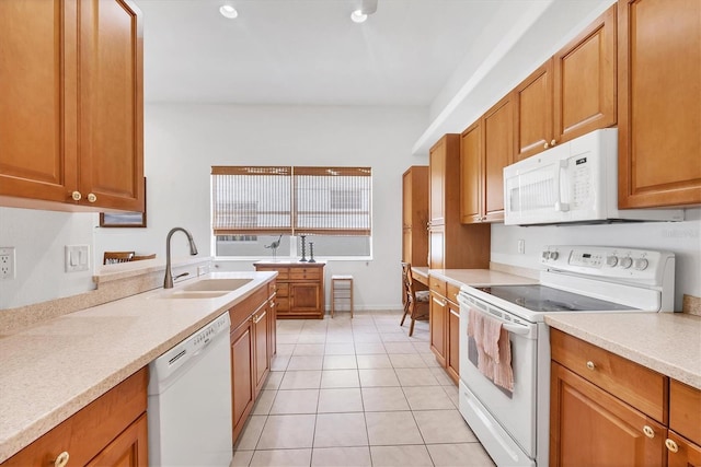2085 Mattamy Ct, Venice, FL 34292 - kitchen featuring white appliances, light tile patterned floors, light countertops, and brown cabinets