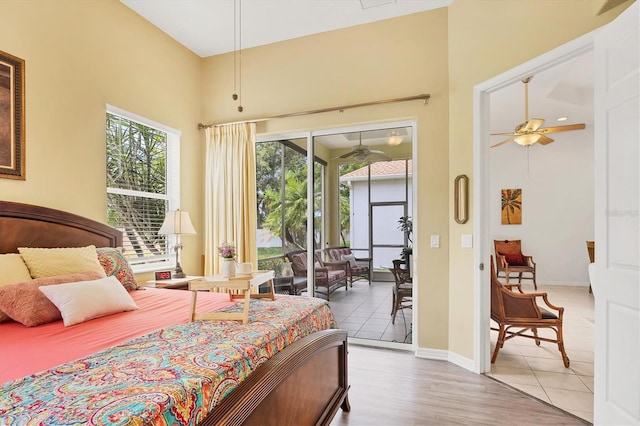 2085 Mattamy Ct, Venice, FL 34292 - bedroom featuring access to outside, a high ceiling, and wood finished floors