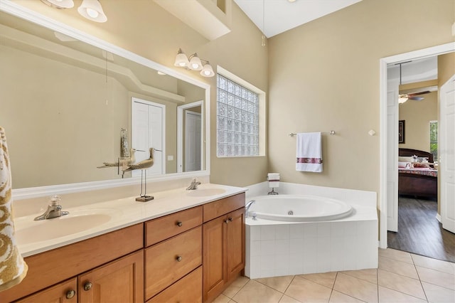 2085 Mattamy Ct, Venice, FL 34292 - ensuite bathroom featuring tile patterned flooring, a jetted tub, double vanity, and ceiling fan