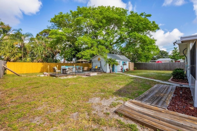 4528 58th St W, Bradenton, FL 34210 - view of yard featuring a deck, an outbuilding, and an outdoor living space