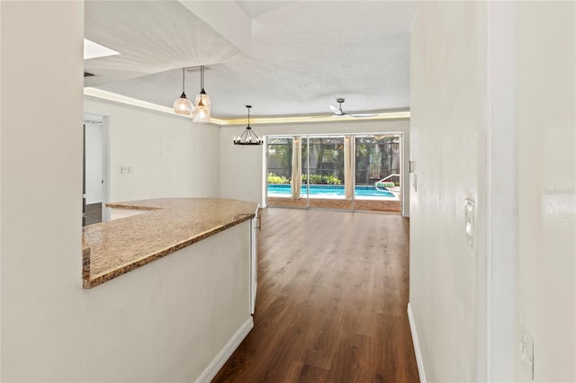 2515 Huntington Ave, Sarasota, FL 34232 - hallway featuring dark wood-type flooring, baseboards, and a chandelier