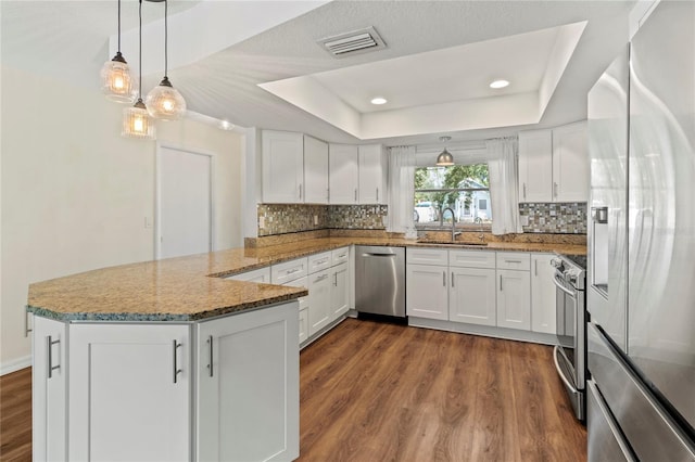 2515 Huntington Ave, Sarasota, FL 34232 - kitchen featuring stainless steel appliances, a sink, a peninsula, white cabinetry, and recessed lighting
