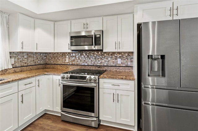 2515 Huntington Ave, Sarasota, FL 34232 - kitchen with stainless steel appliances, white cabinetry, light stone counters, and backsplash