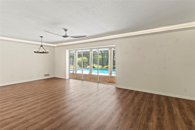 2515 Huntington Ave, Sarasota, FL 34232 - spare room featuring a ceiling fan, a textured ceiling, wood finished floors, baseboards, and a chandelier