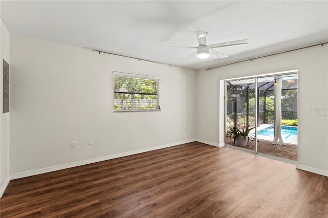 2515 Huntington Ave, Sarasota, FL 34232 - spare room featuring a ceiling fan, wood finished floors, baseboards, a sunroom, and electric panel