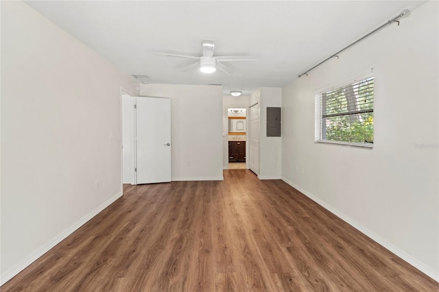 2515 Huntington Ave, Sarasota, FL 34232 - spare room featuring electric panel, wood finished floors, a ceiling fan, and baseboards