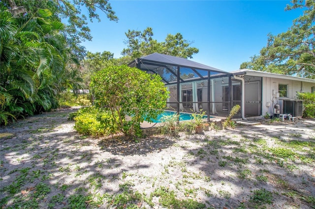 2515 Huntington Ave, Sarasota, FL 34232 - rear view of property featuring an outdoor pool, central AC unit, and a lanai